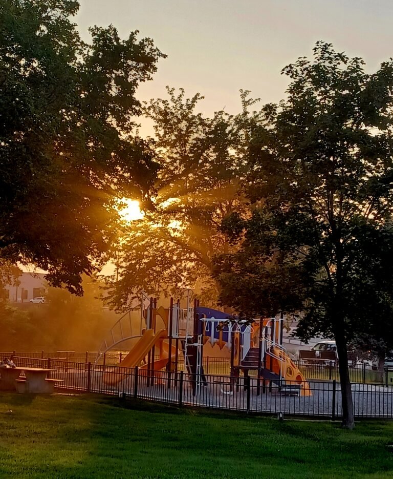Marsing Island Park playground at sunset with wildfire smoke creating a hazy sky in Marsing, Idaho.