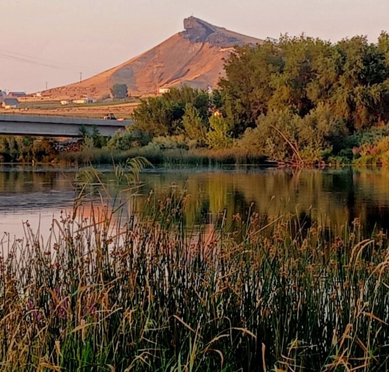 Lizard Butte in Canyon County viewed across the Snake River from Marsing Island Park under hazy wildfire-smoke conditions.