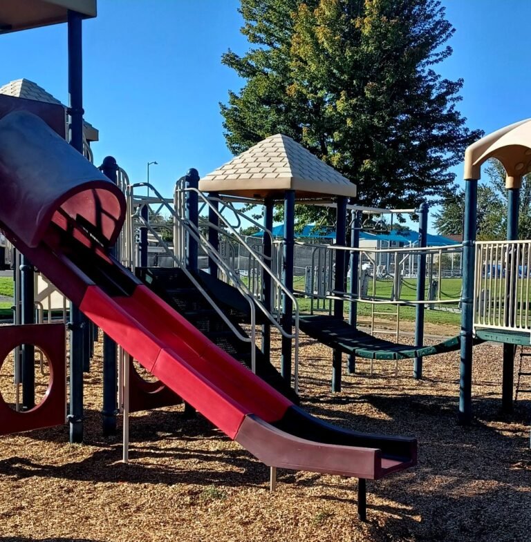 Red slide and playground bridge at Richard Aguirre Park Red slide and playground bridge at Richard Aguirre Park